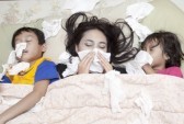16251243-family-is-lying-on-a-bed-due-to-flu-in-winter