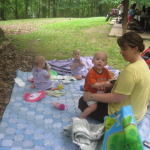 Adorable triplets enjoy some shade with mom