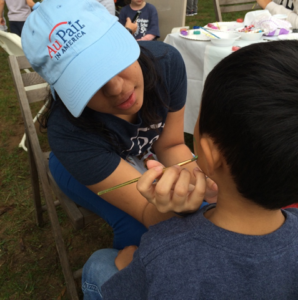 Au pairs provide face painting to kids at the Kinhaven 5k and Fun Run