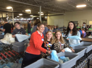 Au pairs and host families smile while helping out.