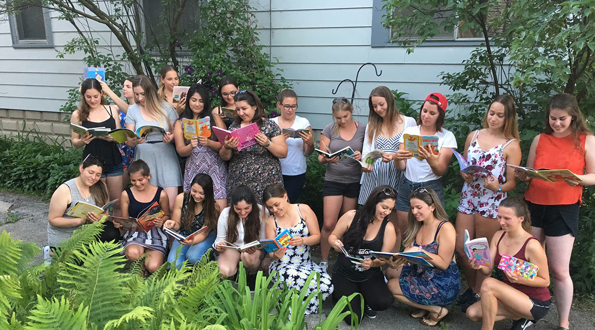 Au pairs read books collected to support Chicago area children's hospital