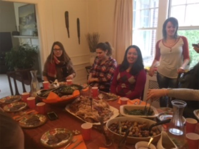 Au pairs gathered around the Thanksgiving table