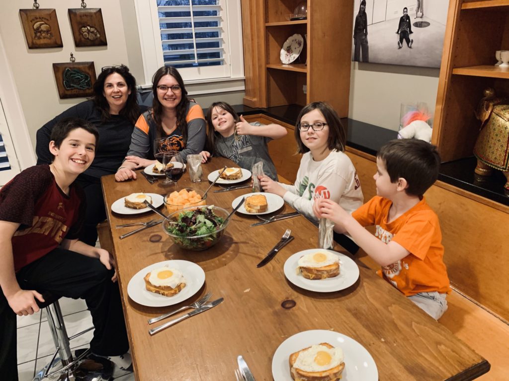 Au pair and host family enjoying a meal together
