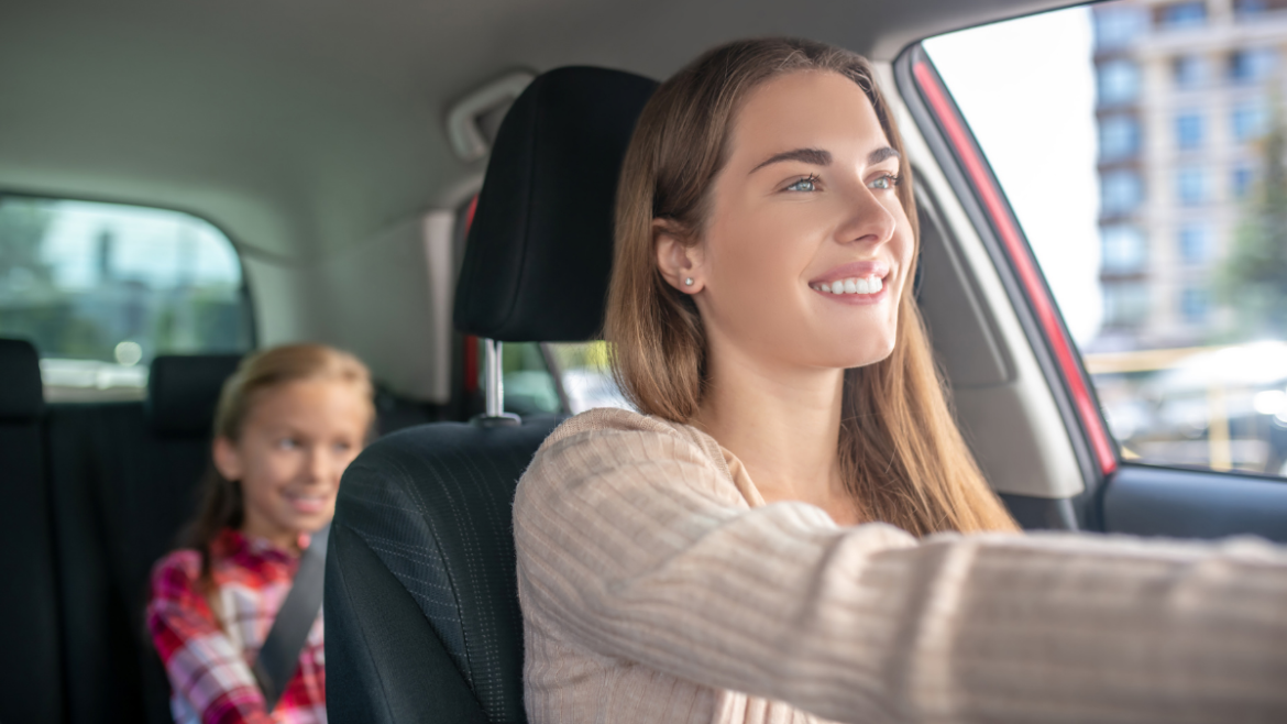 Young Woman Driving with Child in the Backseat | Au Pair in America