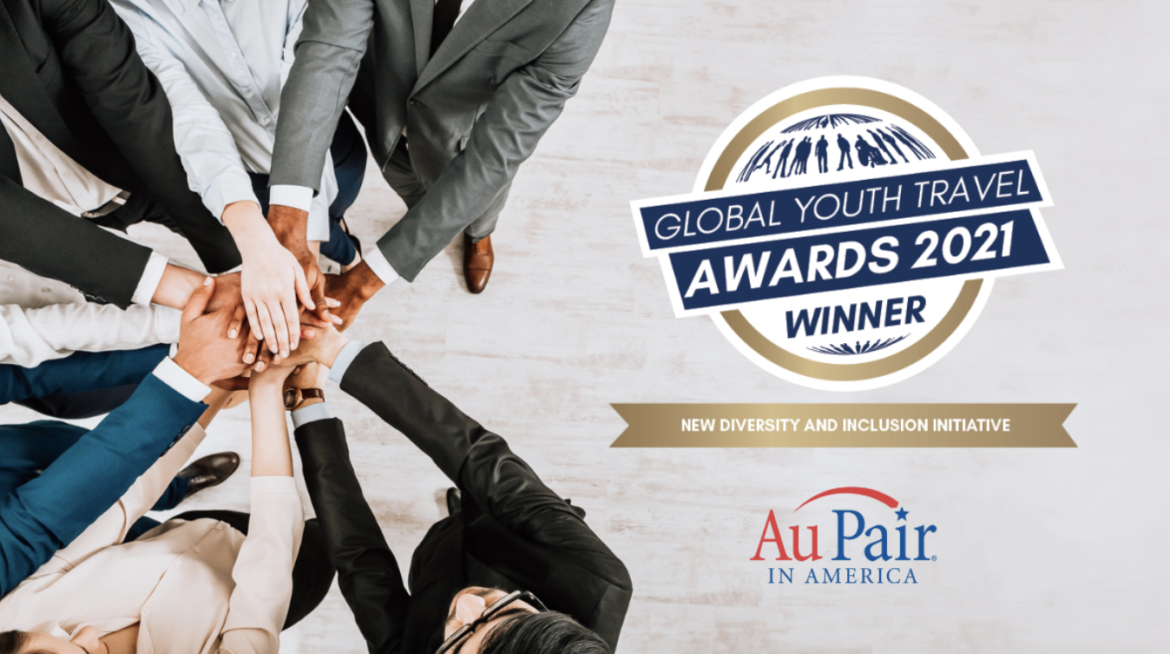 Diverse hands with Au Pair in America logo and Diversity & Inclusion award emblem.