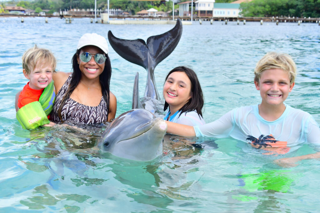Au pair and host children in the ocean - summer