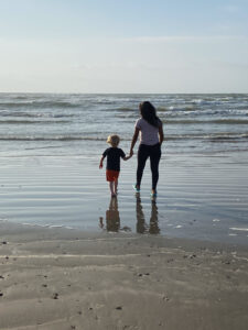 Benefits of hosting an au pair in the summer - au pair and host child at the beach