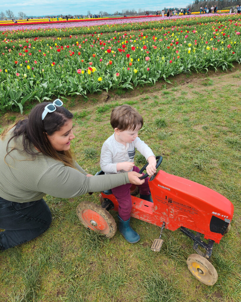 au pair with host child during spring tulips field
