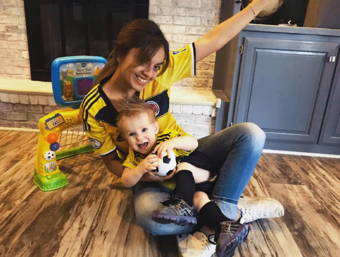 Au pair and host child in soccer jerseys