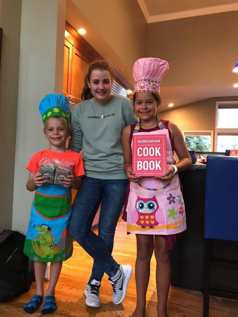 Au pair and host children with cook books