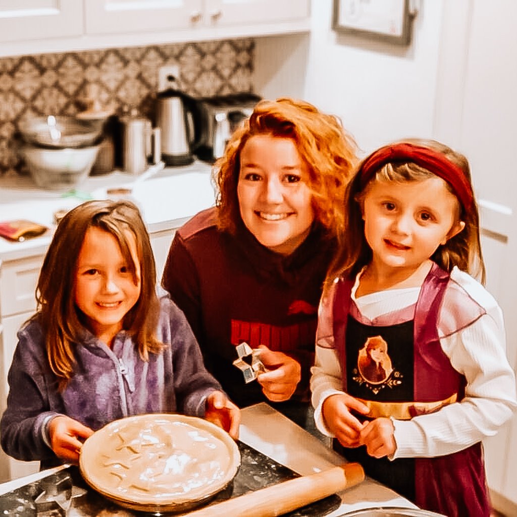 Au pair and host children baking pies