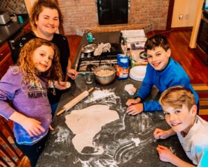 Au pair and host children baking
