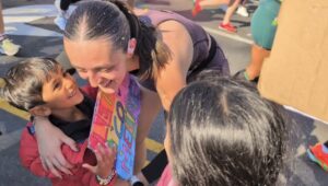 Au pair Méline with host children after running in the 2025 NYC Marathon
