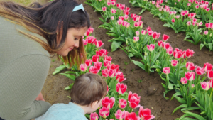 Au pair and host child in the spring with flowers