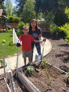 Au pair and host child gardening