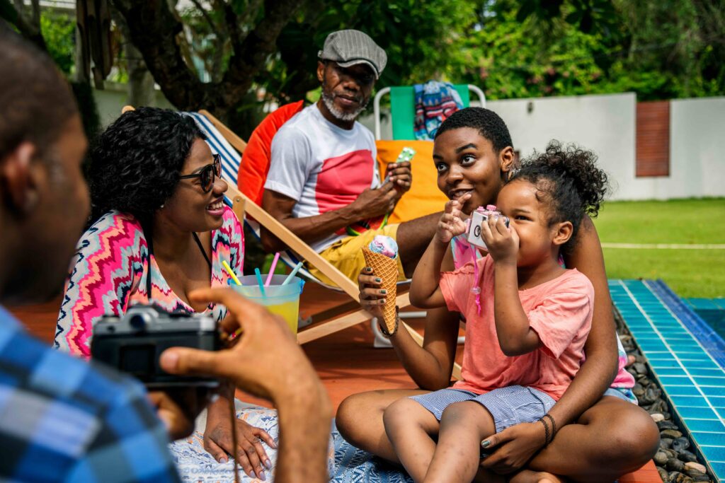 family having ice cream in the backyard during summer
