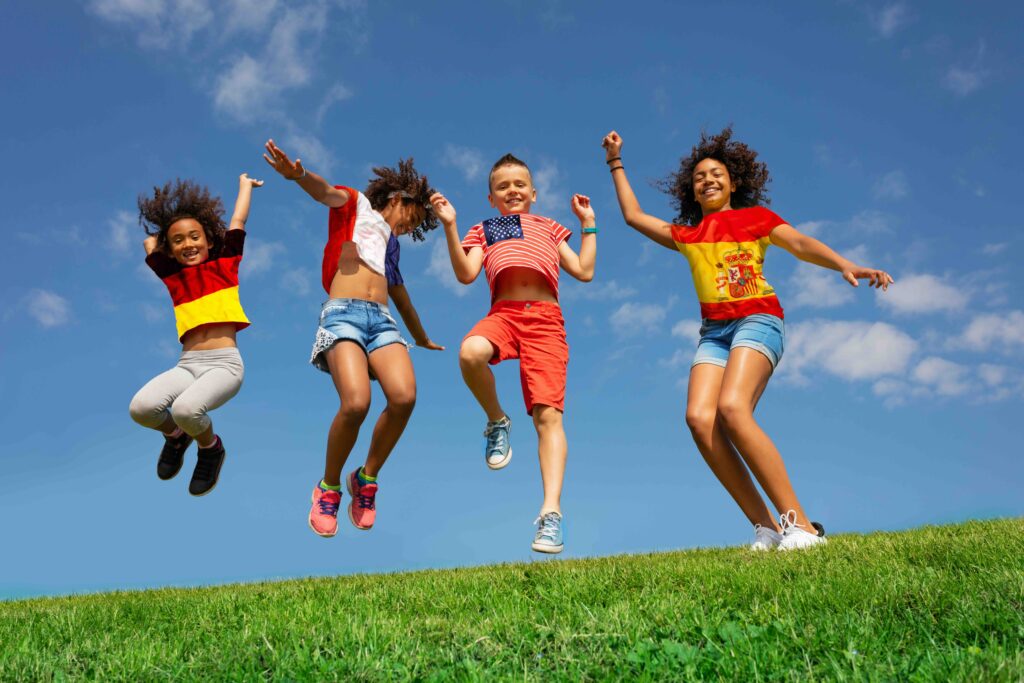 Group of Children at Home Wearing International Flag Shirts Outside