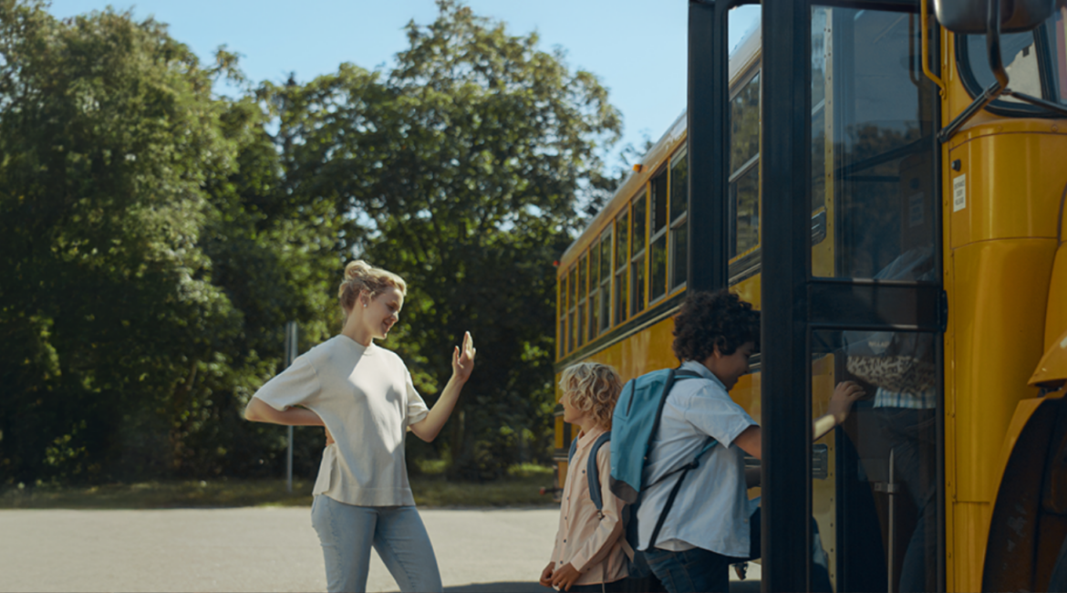 Au Pair and host children getting on the bus