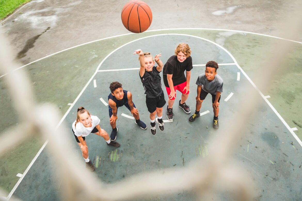 kids playing basketball together outside afterschool activity